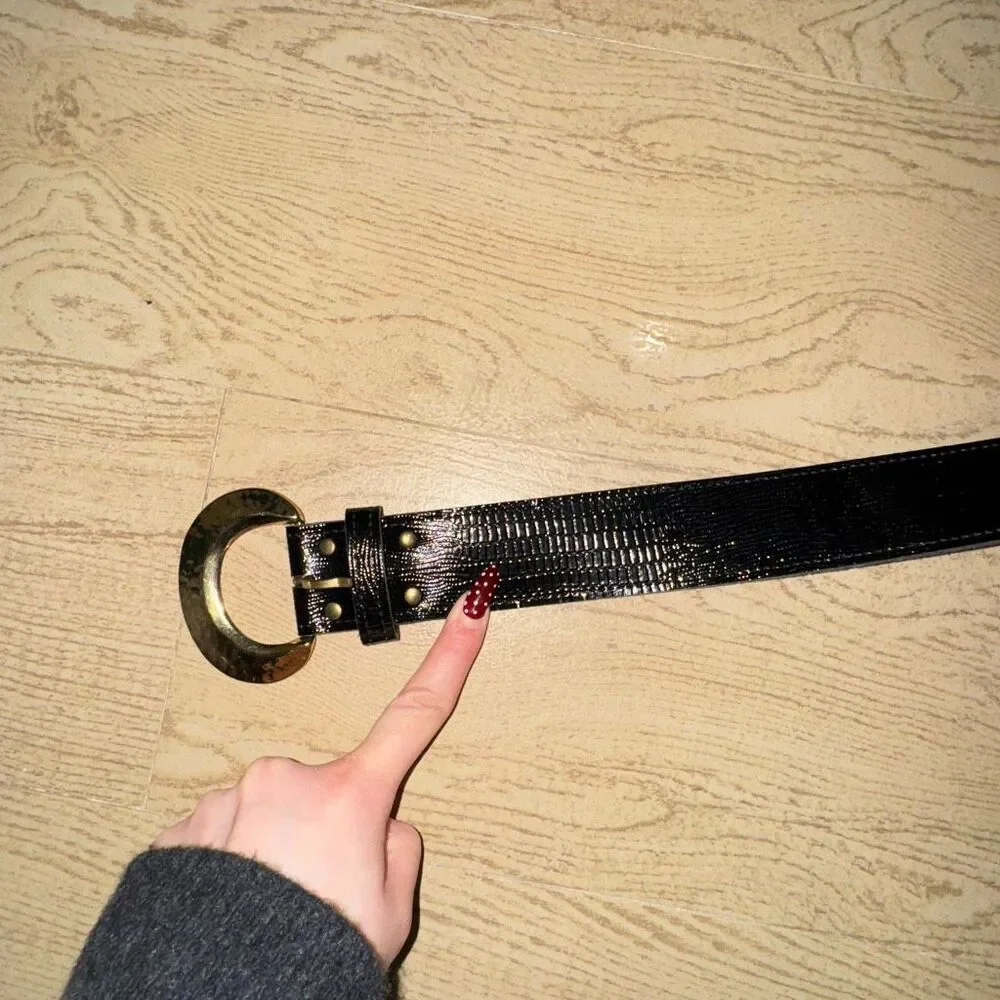 black patent leather belt with a large gold buckle, possibly a vintage 80's styl